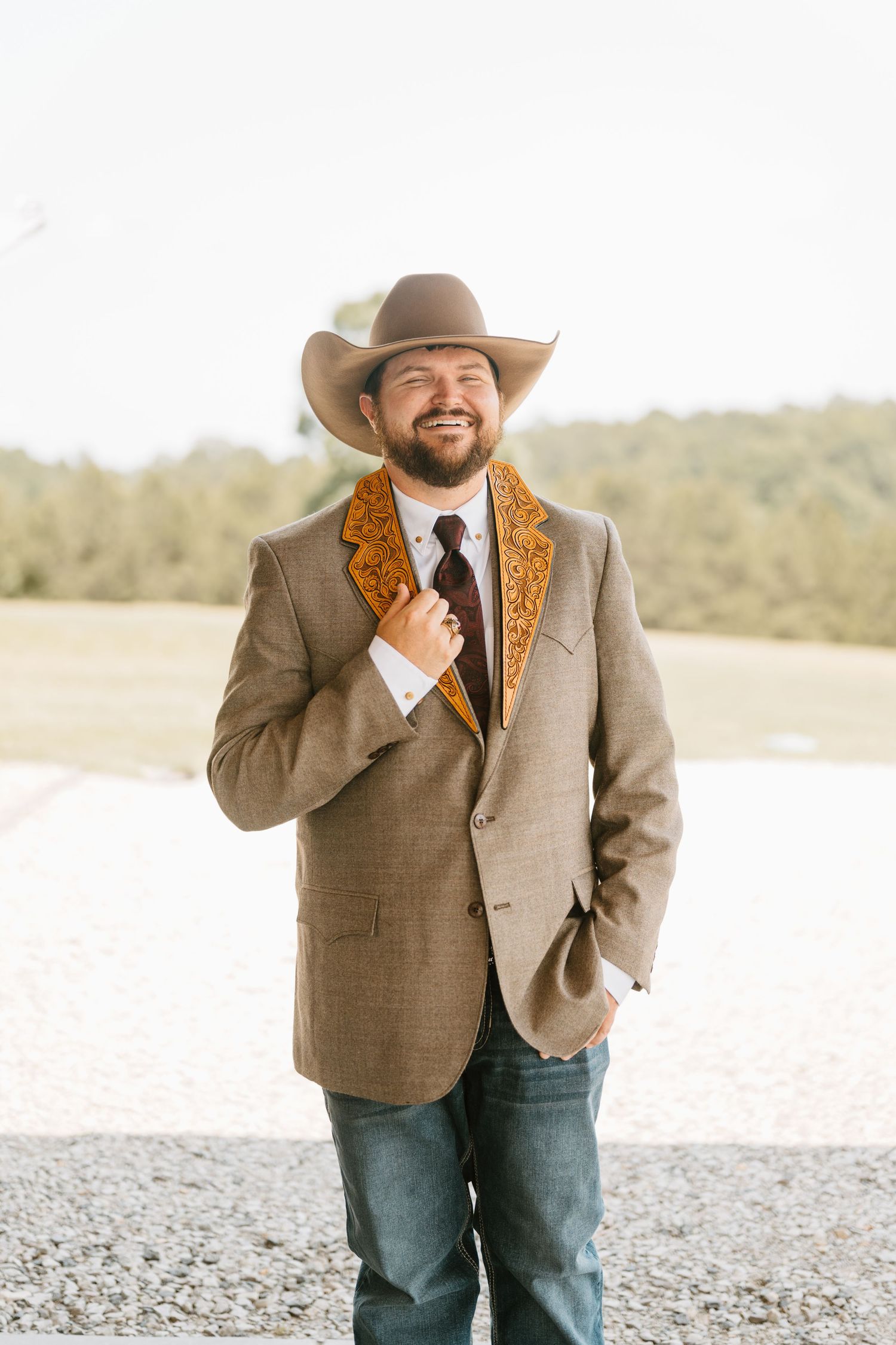 Intimate Western Wedding Couple Portraits at the Barn at Greers Ferry Wedding Venue Near a Lake in Arkansas Leather Suit Jacket