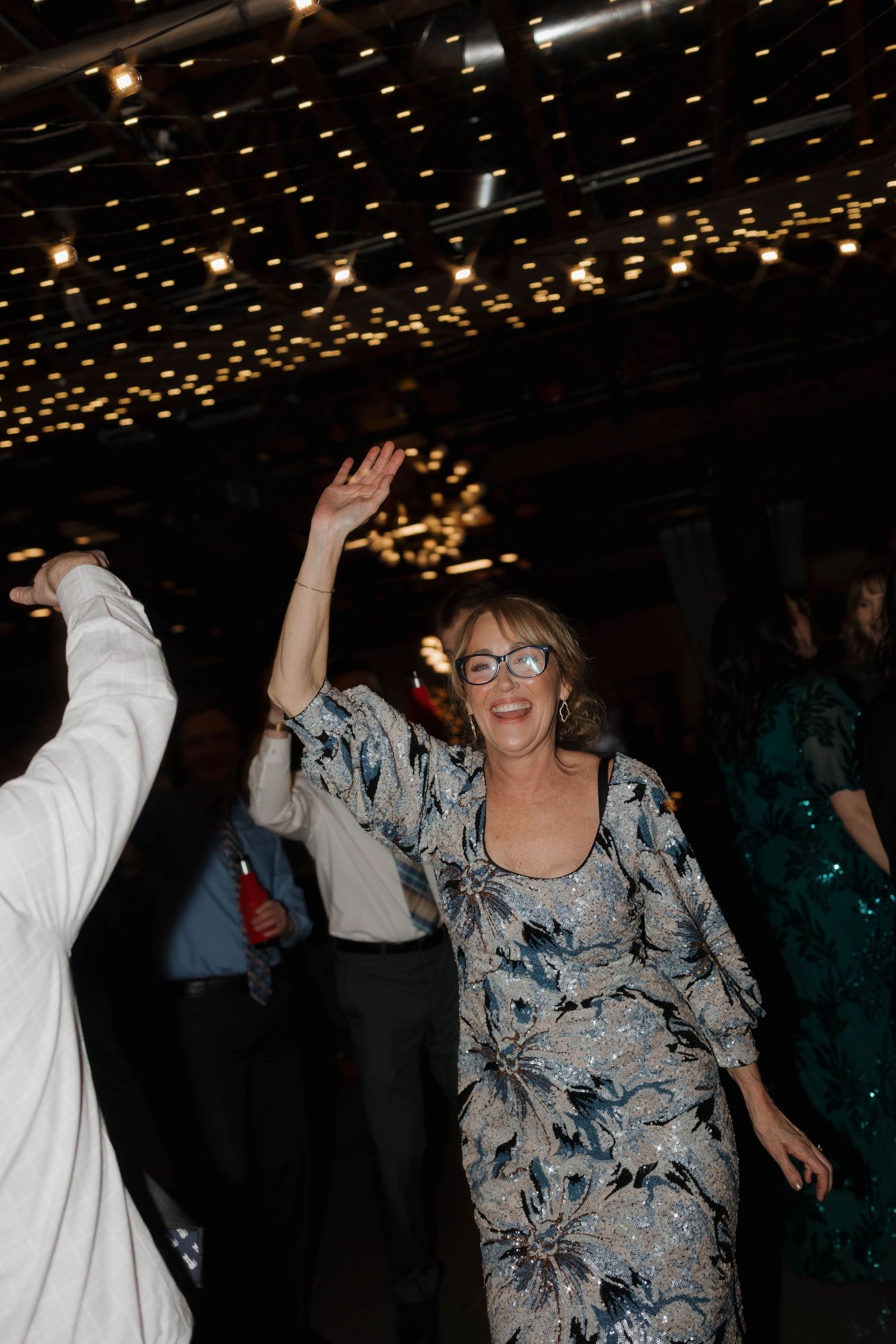 Dance party scene with string lights overhead creating a festive atmosphere.