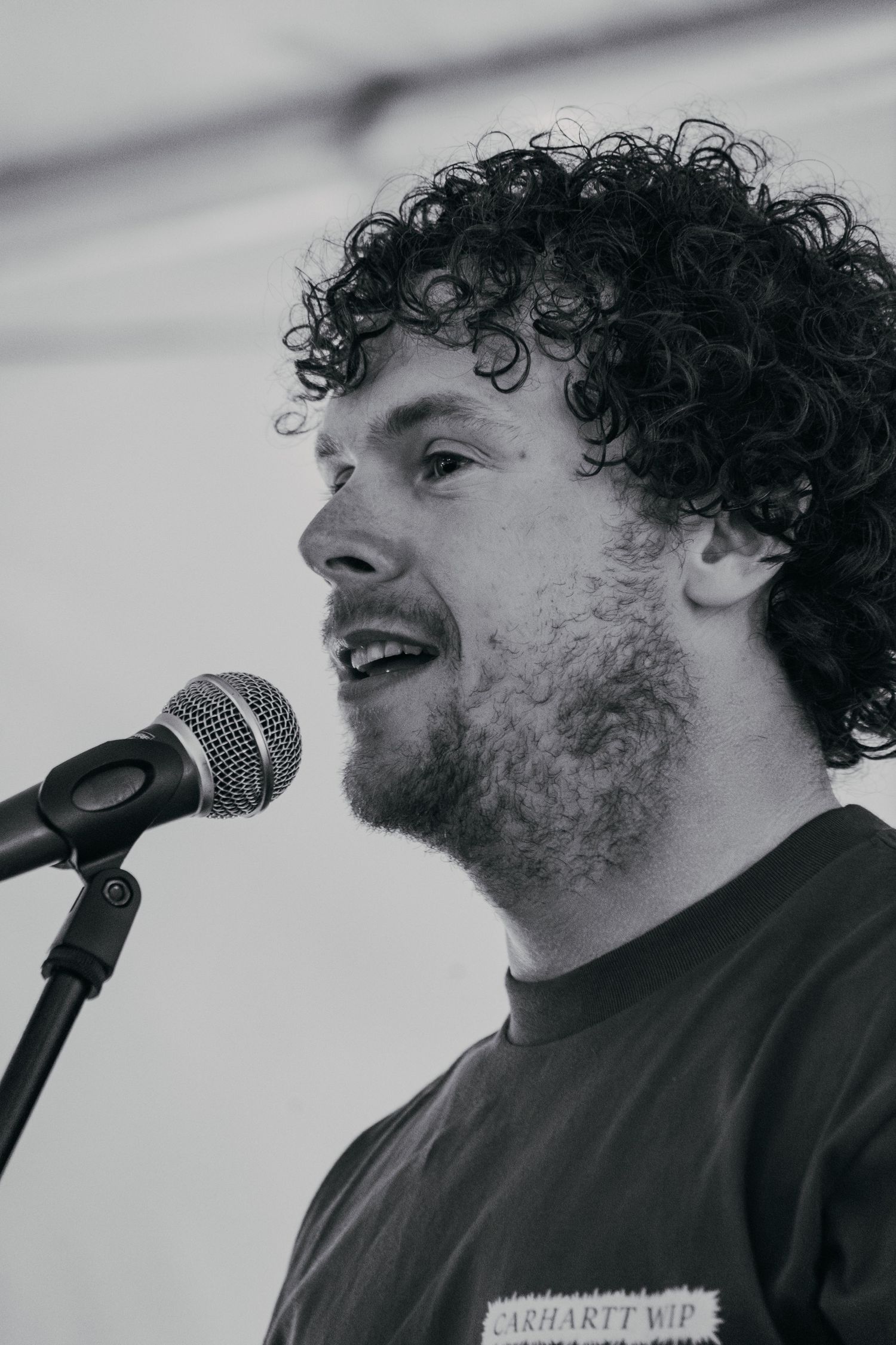 A performer sings into a microphone during a live performance.