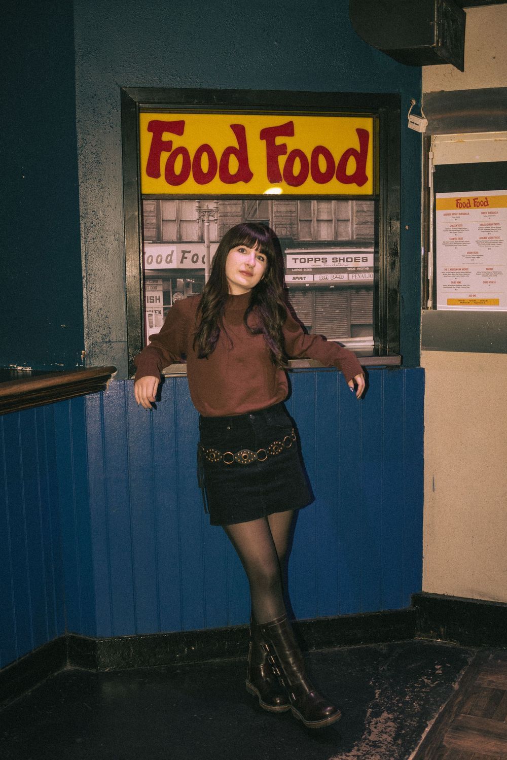 Retro-style storefront with yellow 'Food Food' sign and blue painted walls in urban setting.