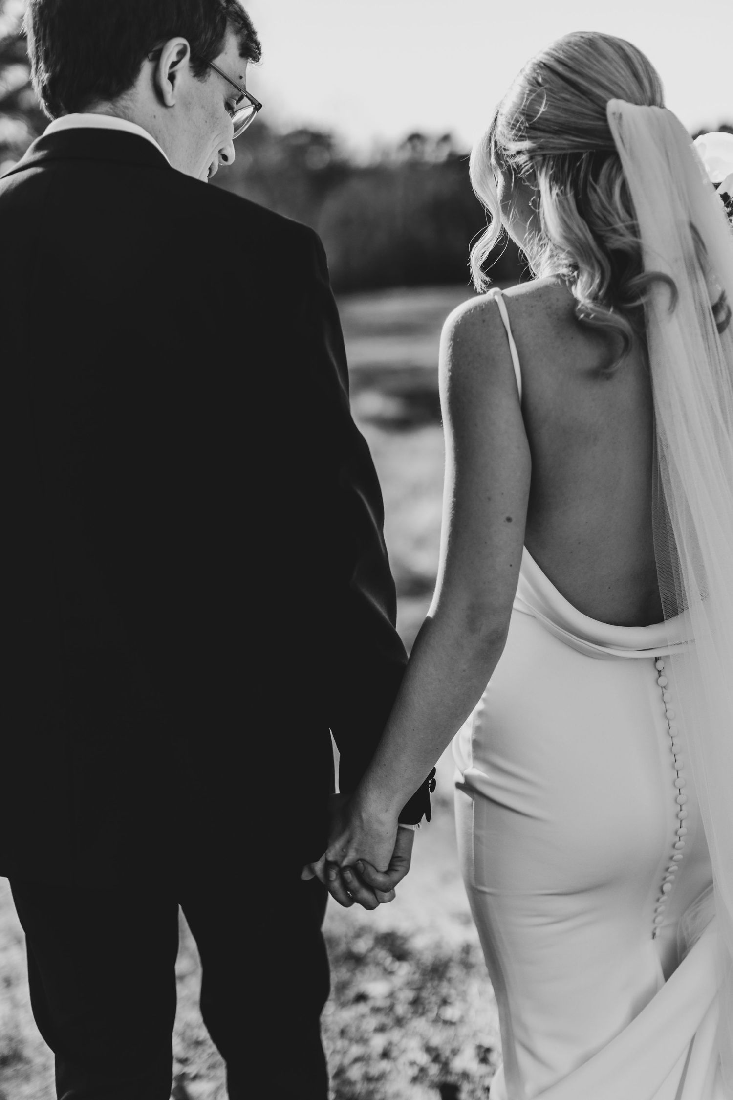Details of elegant white wedding dress with button closures down the back.