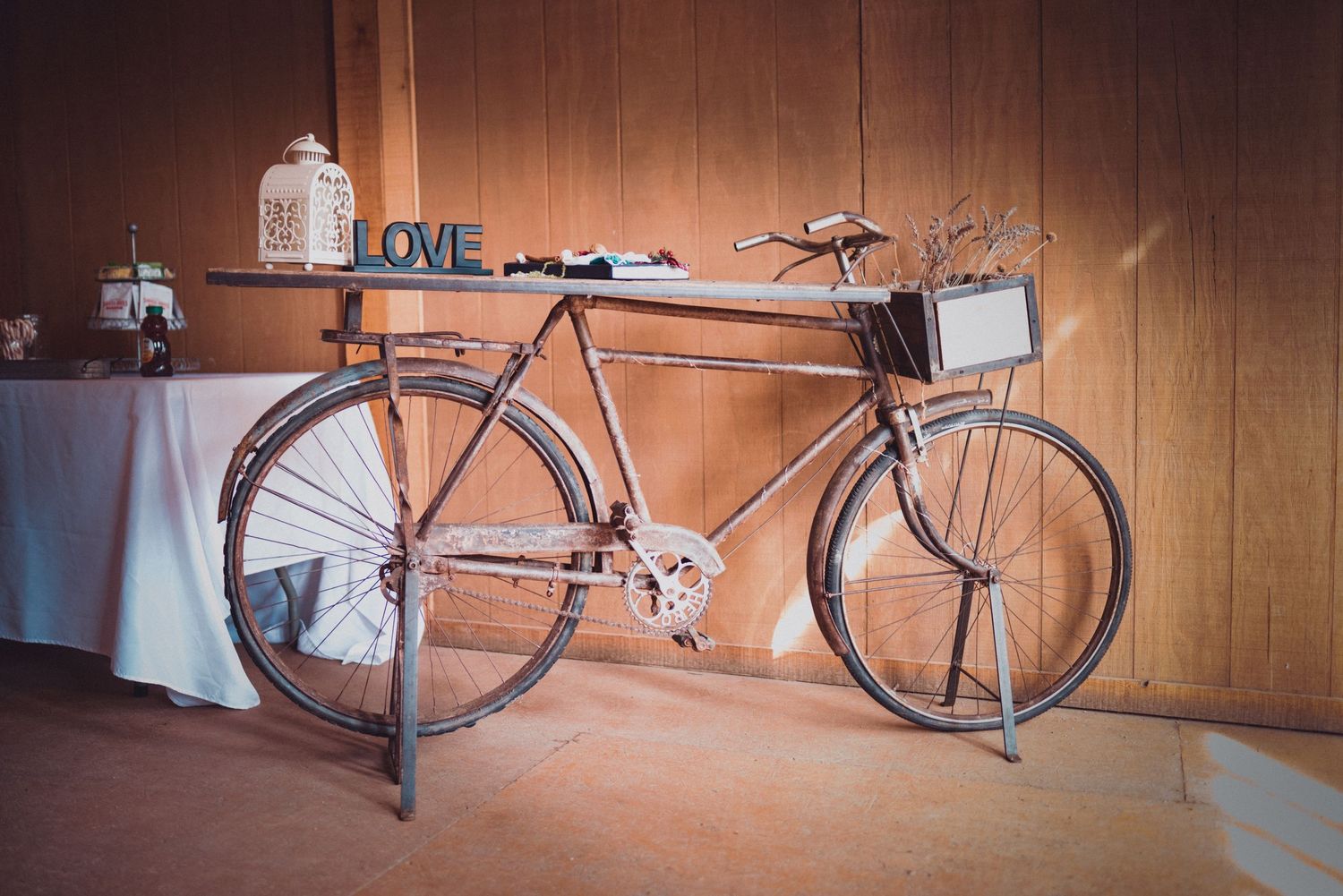 a picture of a bicycle that has been converted to a table at the entry to Old Town Farms.