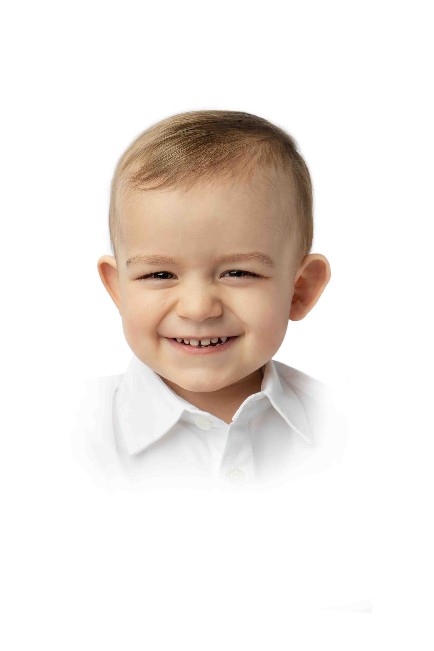 toddler boy grins at camera in heirloom portrait