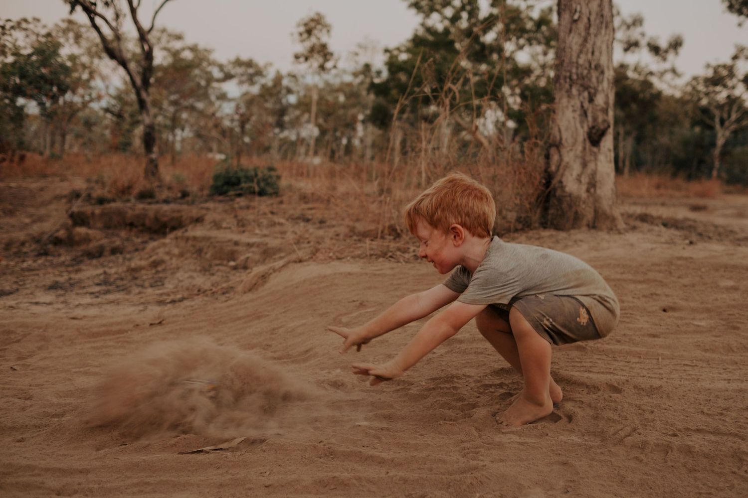 Boy playing in the dirt