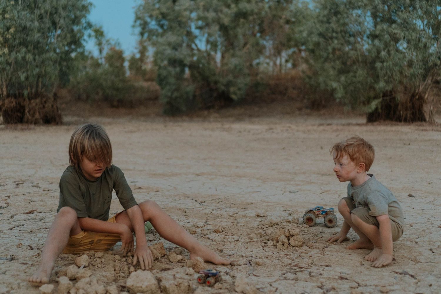 Two children playing in the dirt