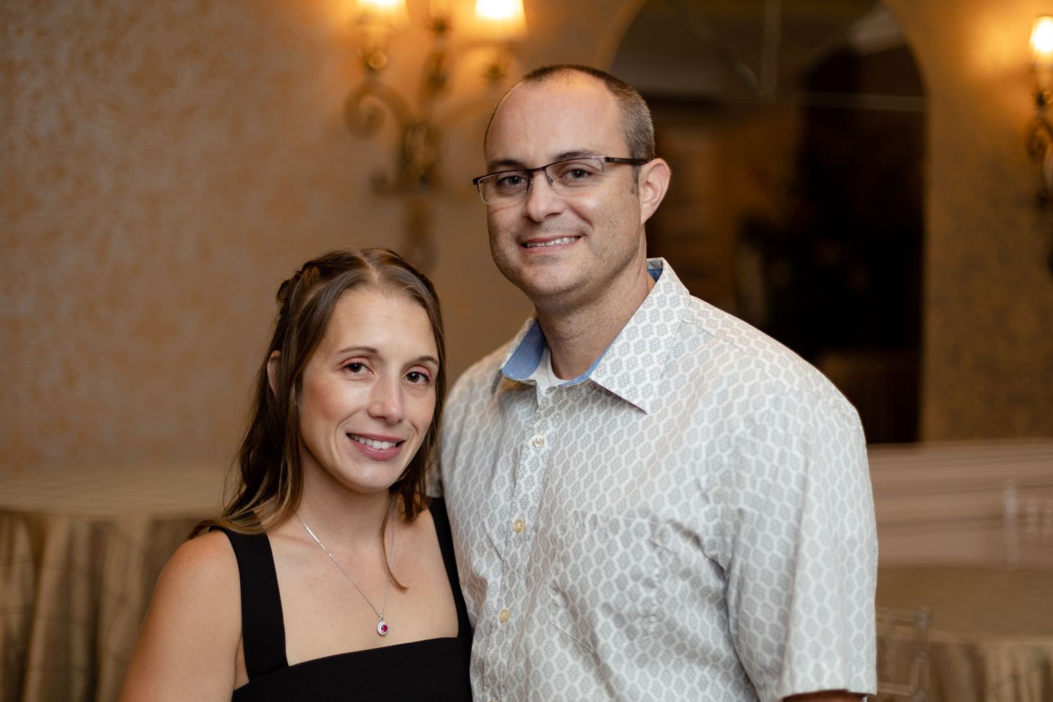 Couples enjoying themselves at an indoor celebration with warm lighting.