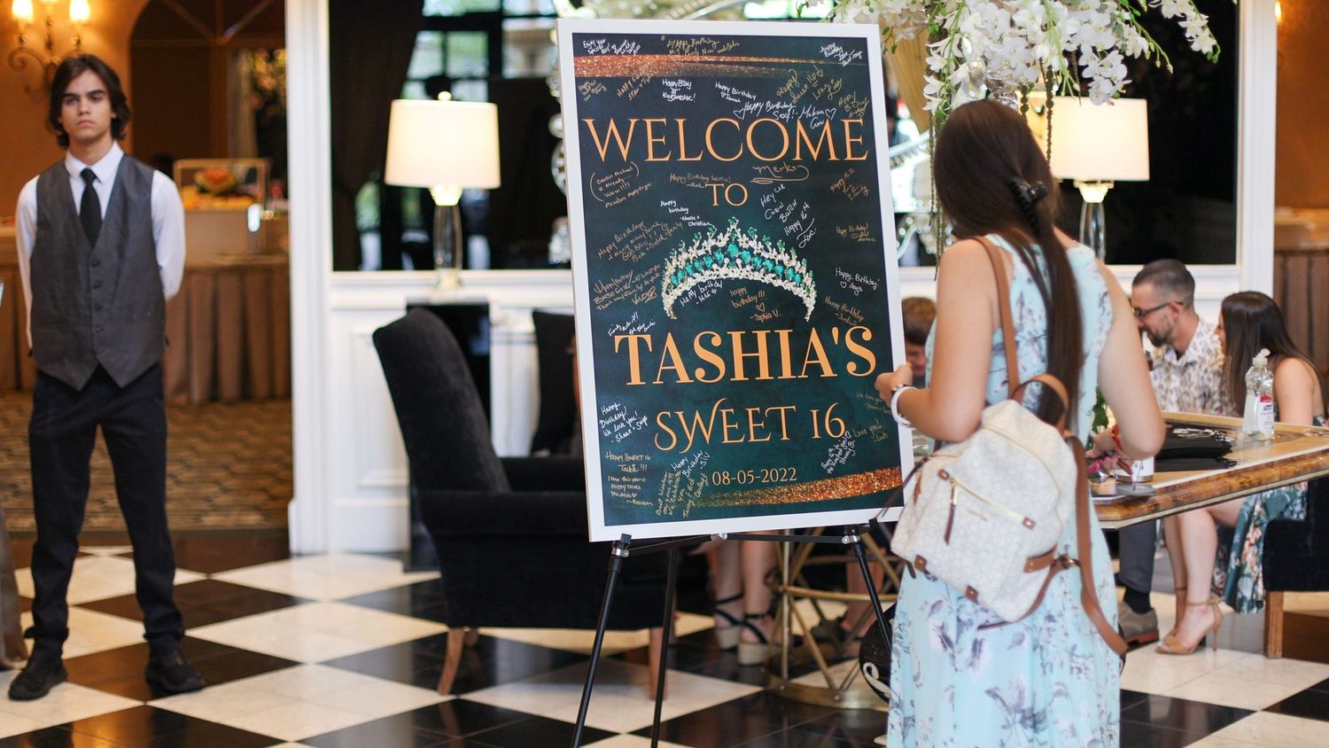 Welcome signs and decorative elements at an elegant indoor celebration.