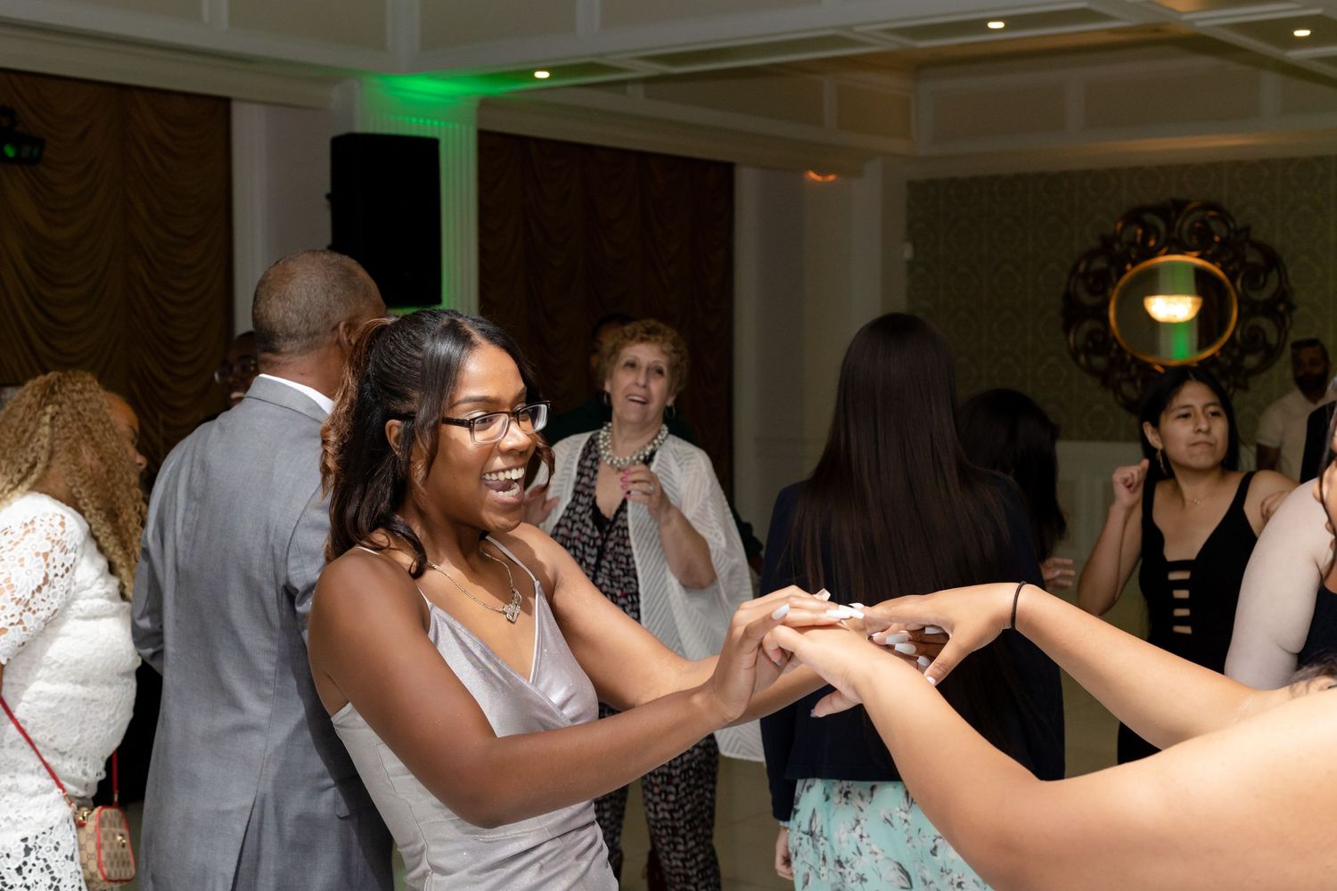 Guests dancing and socializing at an elegant indoor reception.
