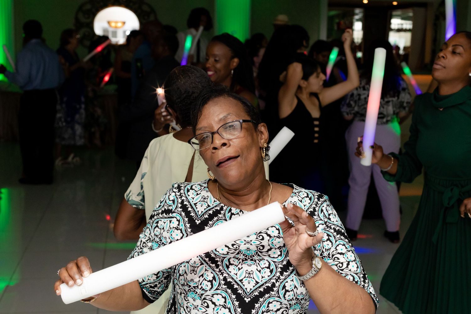 Energetic dance floor moments during a wedding reception with festive lighting effects.