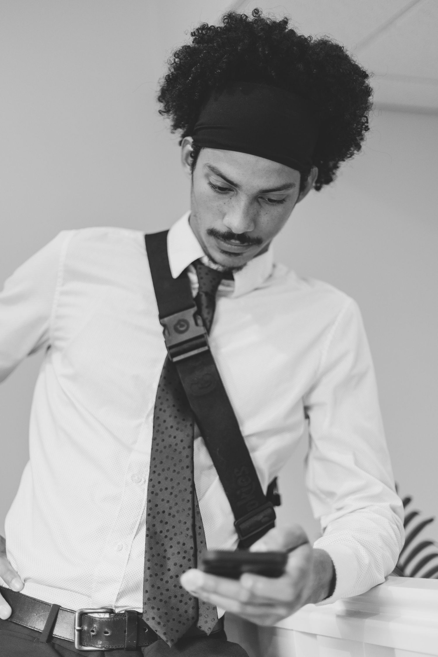 Black and white photos showing someone adjusting their tie.