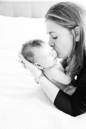 An intimate black and white portrait showing tender closeness between two people.