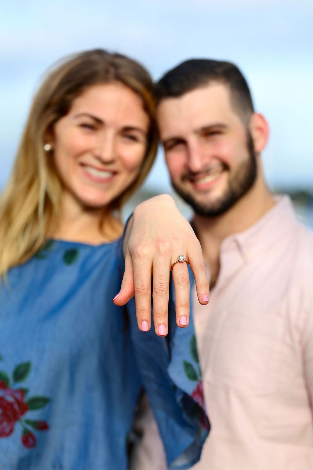 A Couples photo with the woman showcasing the ring.