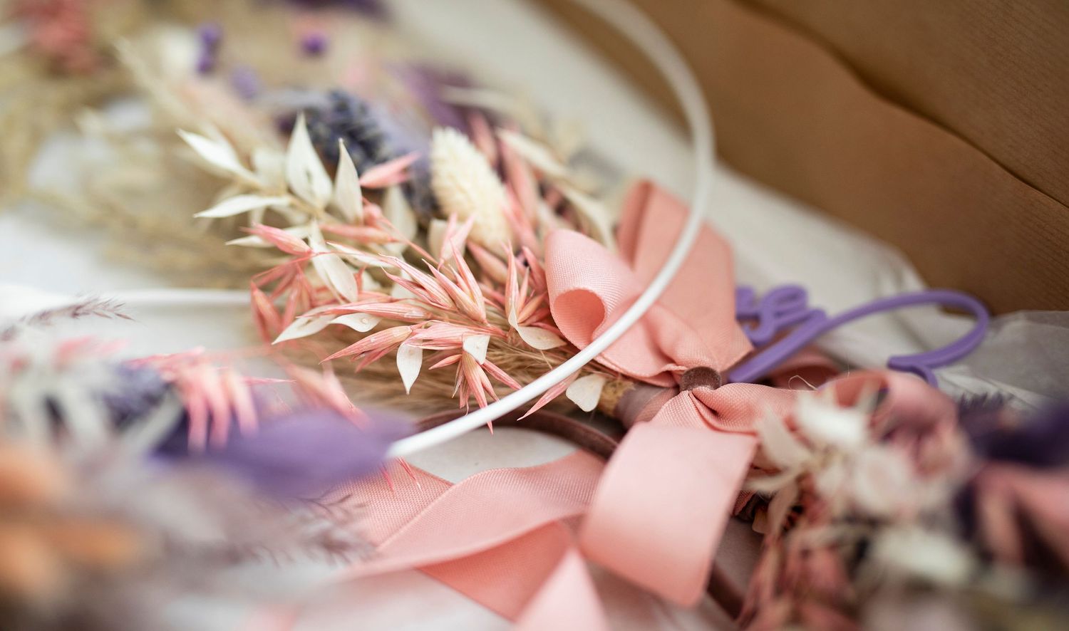 Delicate pink and purple wedding decorations arranged with soft focus and romantic lighting.