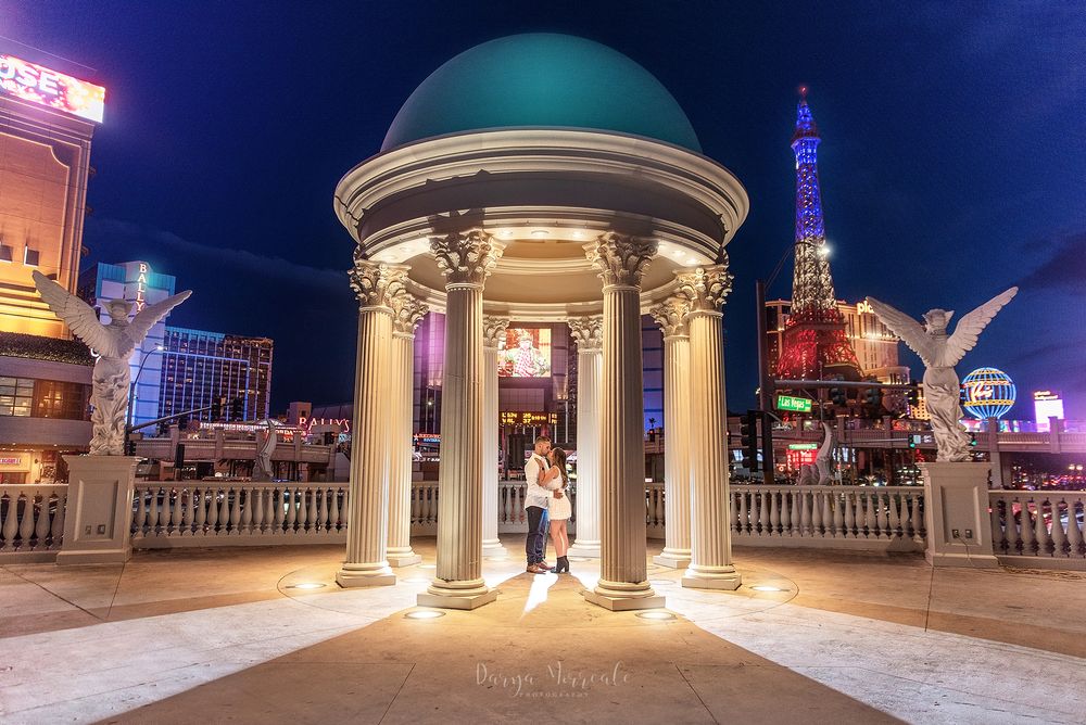 Illuminated gazebo with domed roof against night sky at Las Vegas resort.