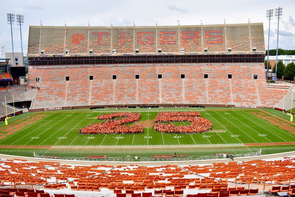 Aerial view of Memorial Stadium with students forming '2023' on football field.