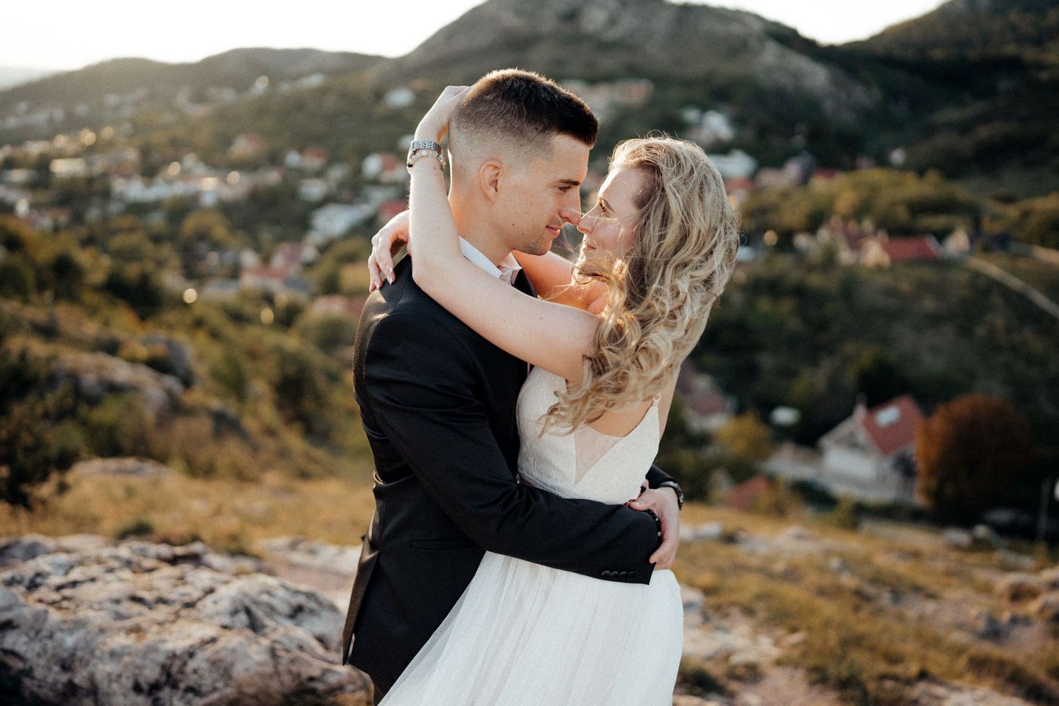 Couple sharing intimate moment during mountain sunset photography session.