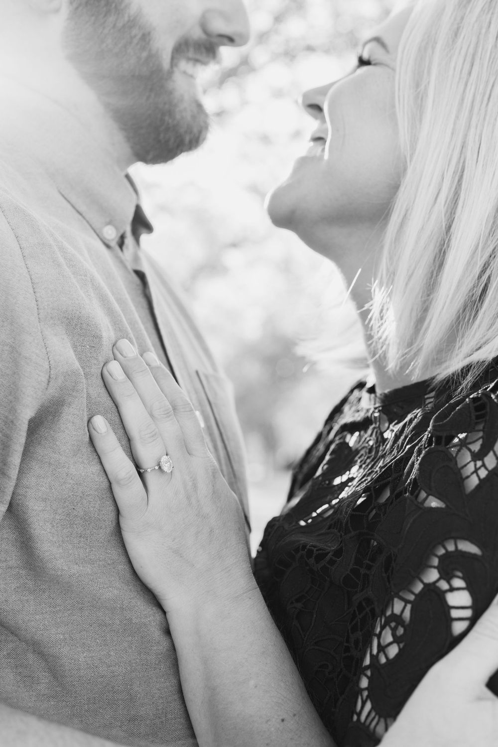 happy timeless couple smiling at each other showing off engagement ring in missouri