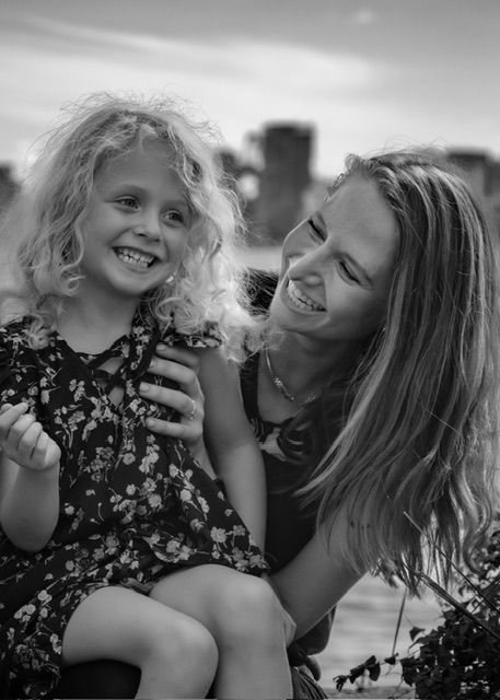 Mom and daughter laugh together in fun black and white photo at Shipyards North Vancouver