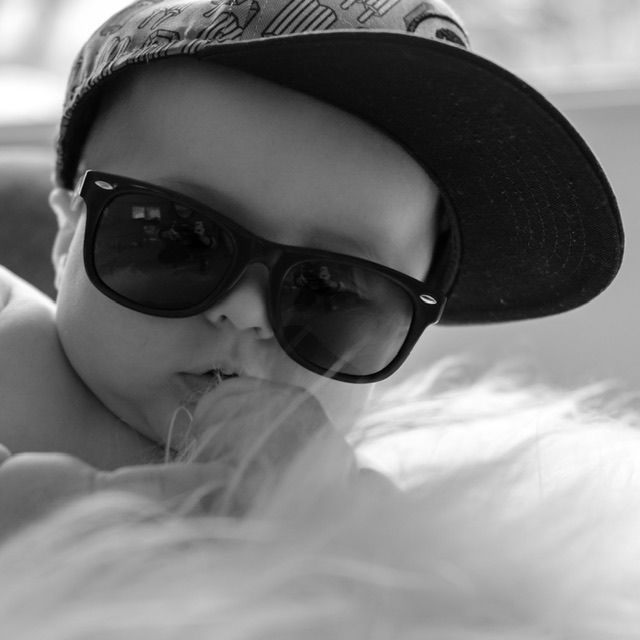 Black and white portrait of young child wearing sunglasses, candid family photo, North Vancouver