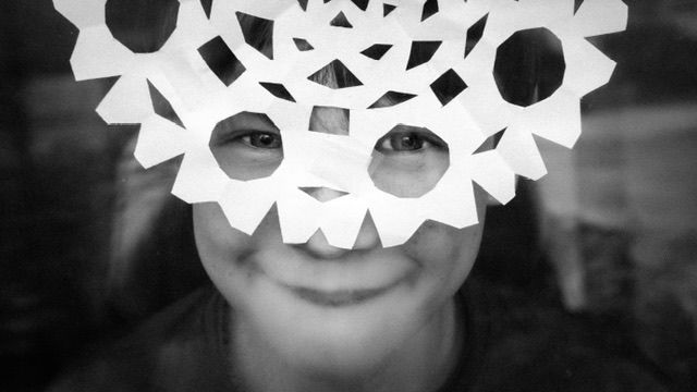 Black and white portrait of woman wearing snowflake mask, playful portrait, North Vancouver photographer