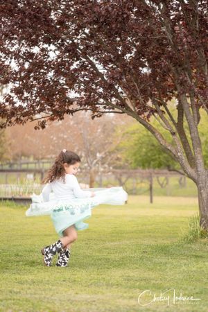 Lennea twirling during her fourth birthday photos at Crossroads Ranch