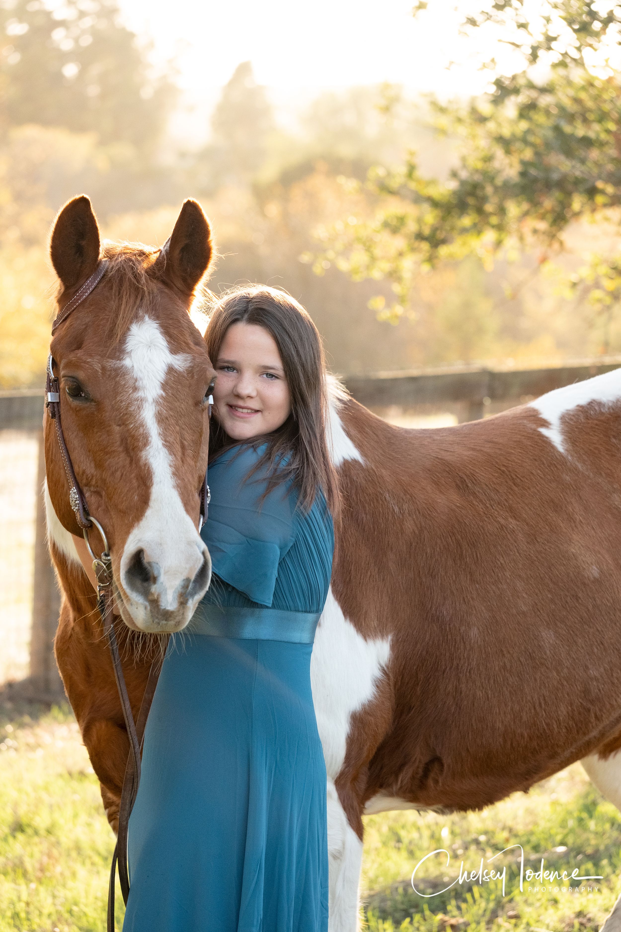 Makenna hugging ranger for birthday photos in blue dress in Petaluma