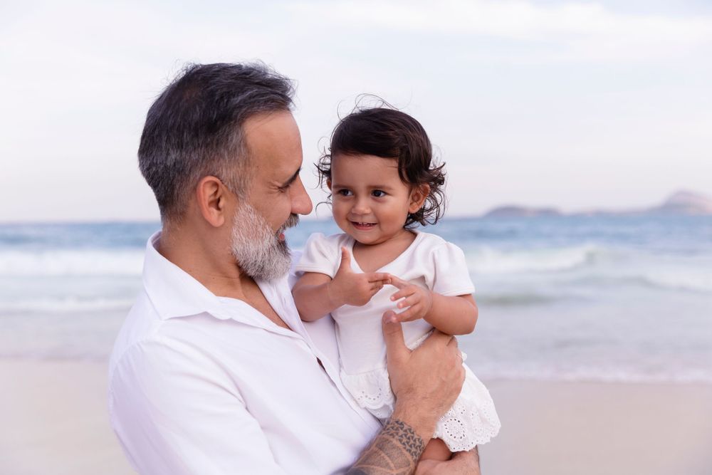 Sweet moment between adult and young child enjoying time together by the ocean.
