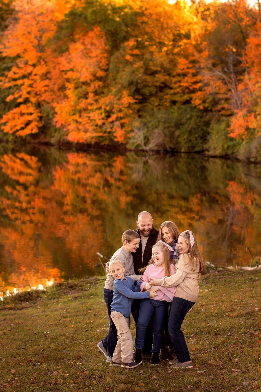 family laughing together in the autumn