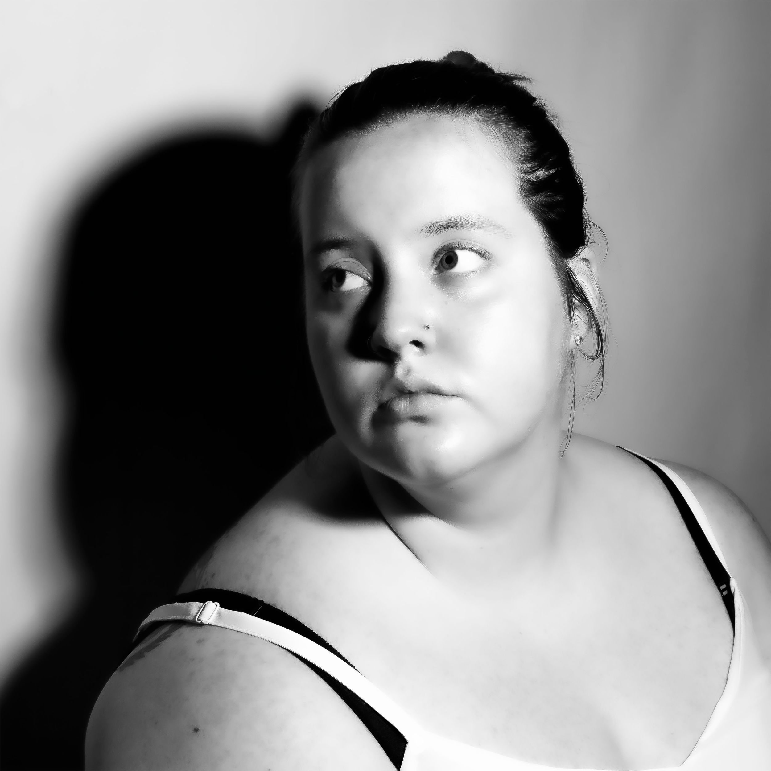 A dramatic black and white portrait series with strong shadow play and contrast.