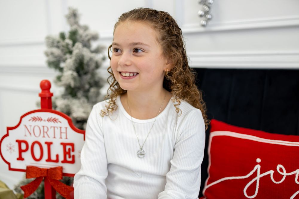 curly hair girl smiling for christmas photo