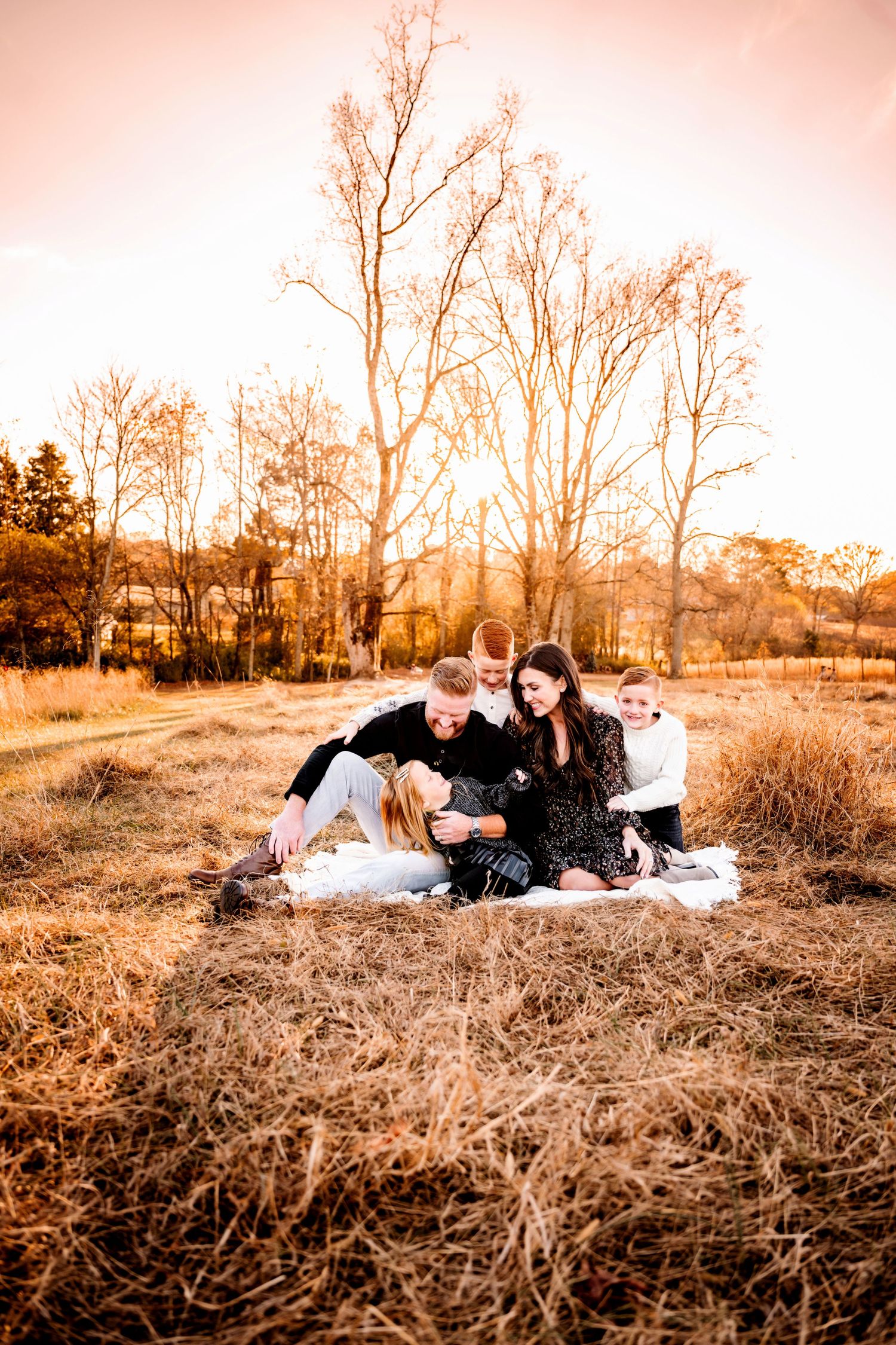 Sunset photoshoot in a golden field with warm autumn tones.