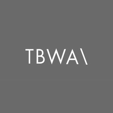 Grey and white TBWA advertising agency logo on dark background.