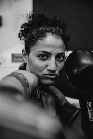 Close-up black and white portraits showing intense focus during boxing training.