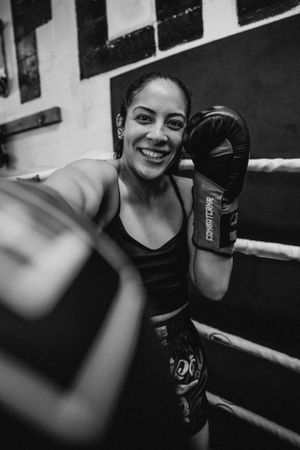 Series of boxing portraits showing smiles and determination while wearing black gloves.