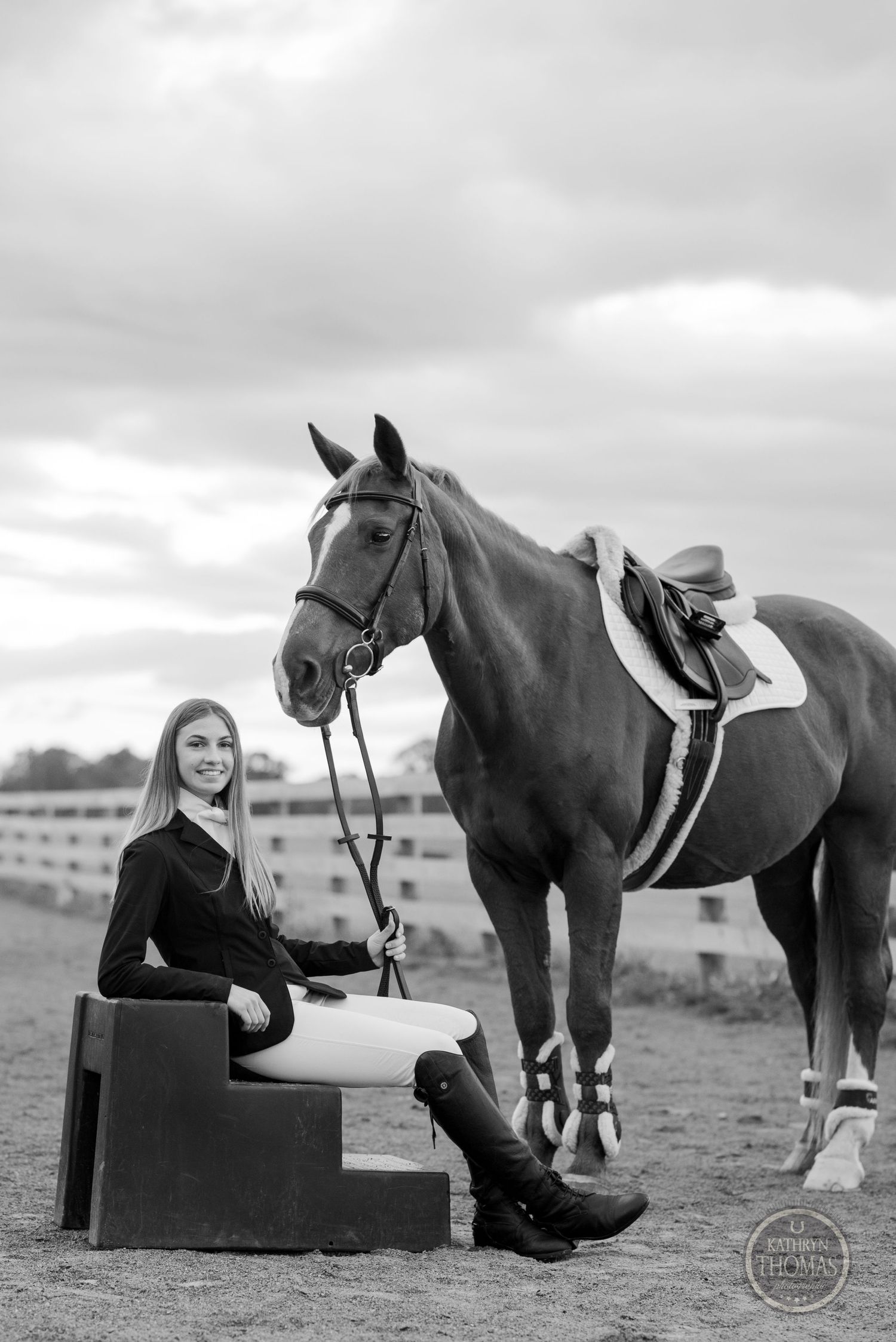 Elegant equestrian portrait with saddled horse in black and white photography.