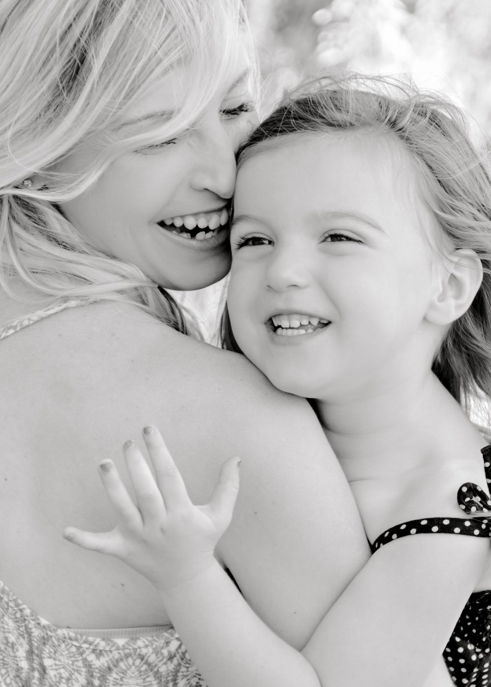 A touching black and white close-up portrait showing joy and laughter.