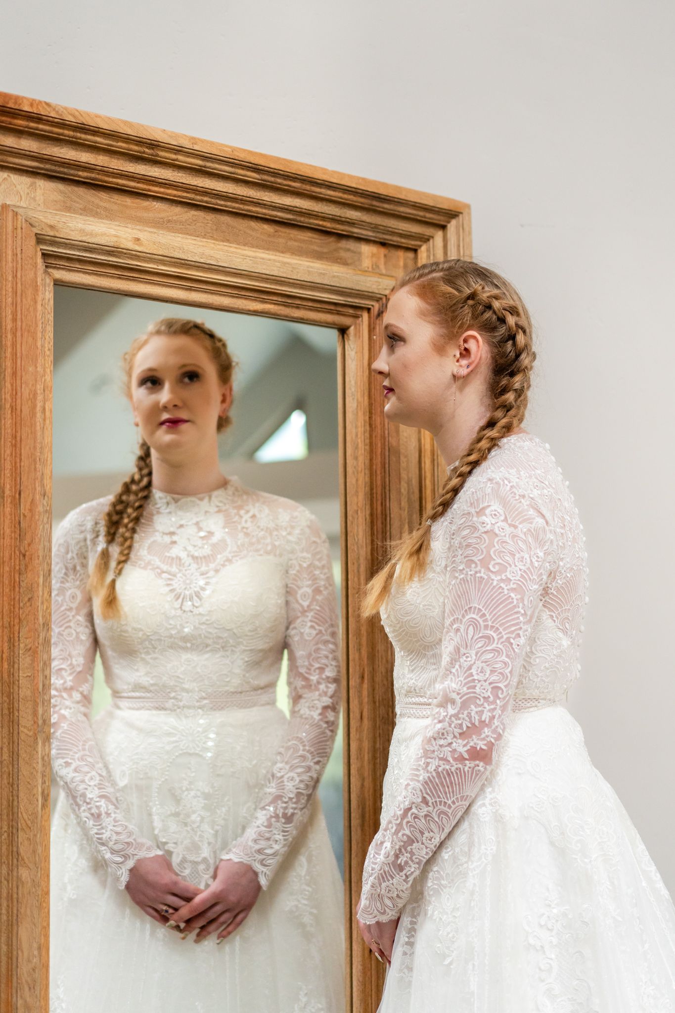 bride looks in a mirror