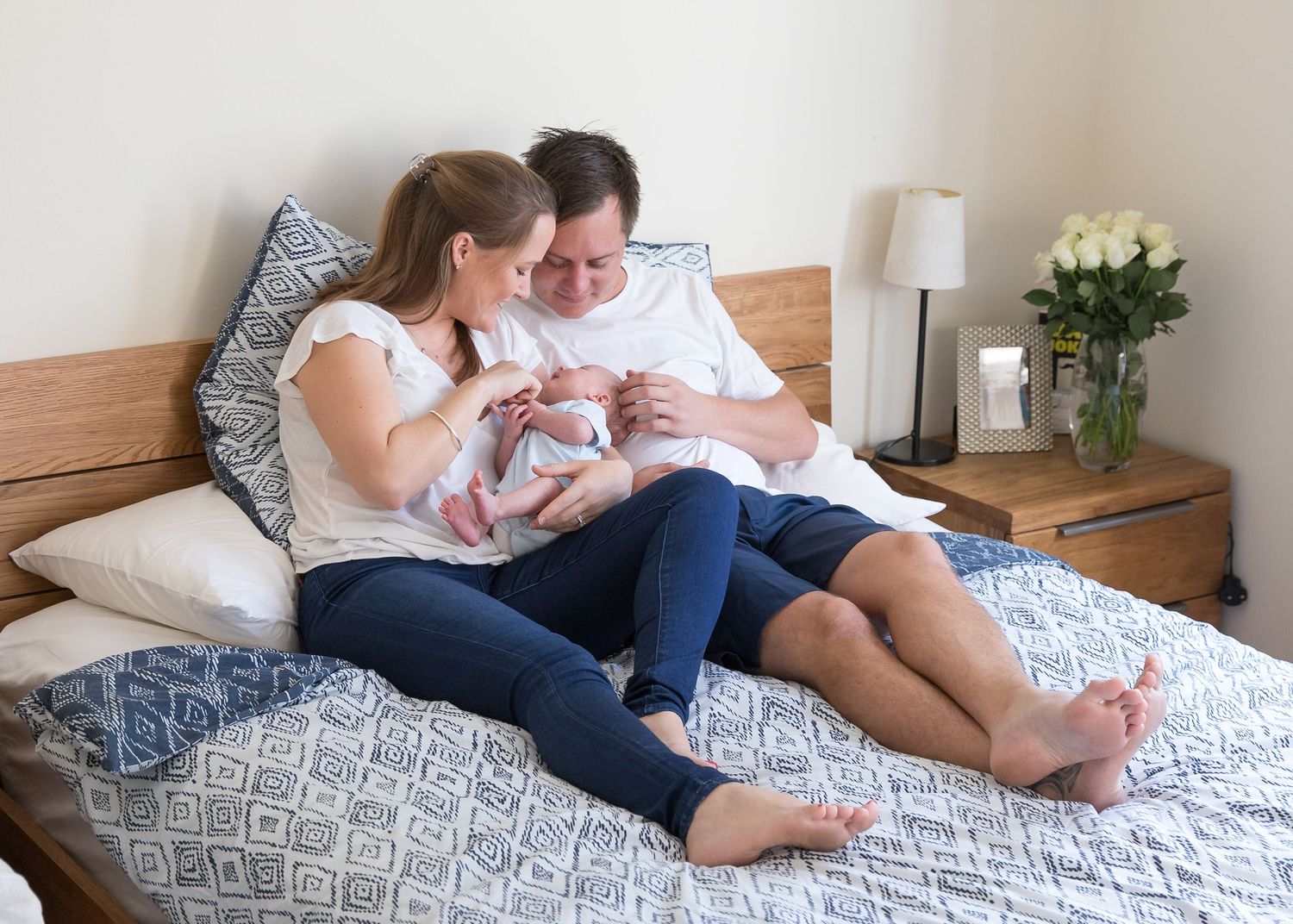 newborn photoshoot on master bed - blue and white colour scheme