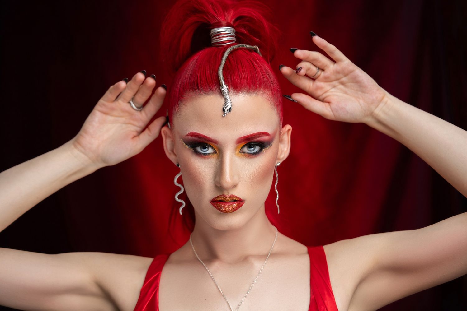 Orlando glamour photographer Ray Alvarez — dramatic red editorial glamour portrait with bold makeup and expressive posing