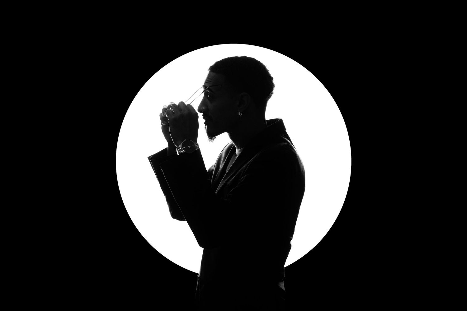 Orlando creative portrait photographer Ray Alvarez — dramatic studio silhouette portrait with bold circular lighting