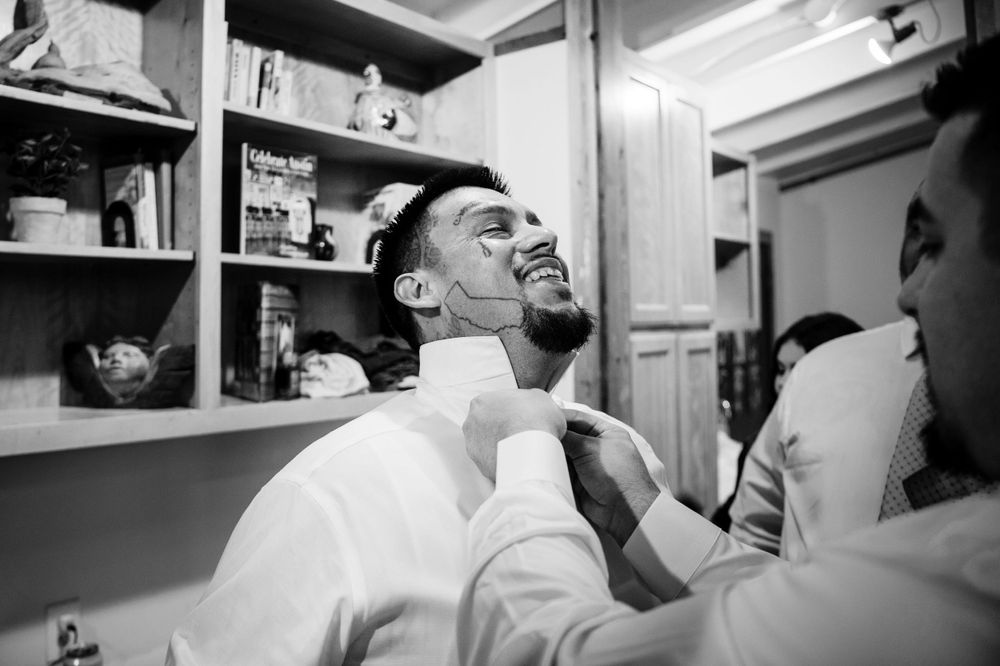 Black and white image of pre-wedding grooming preparation in bathroom setting.
