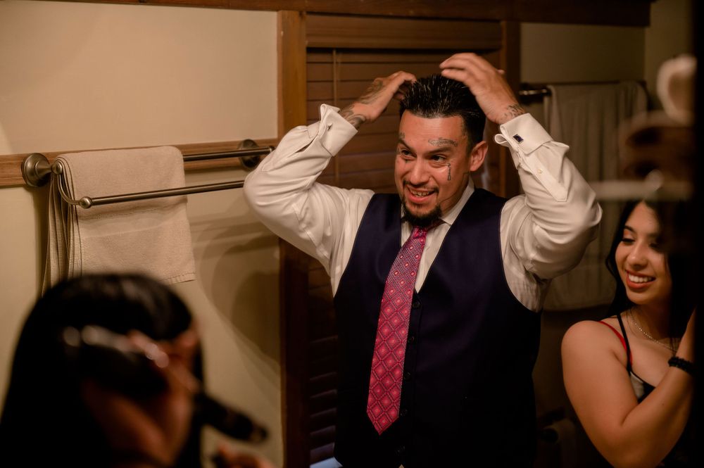Wedding guests share a lighthearted moment during reception celebrations.