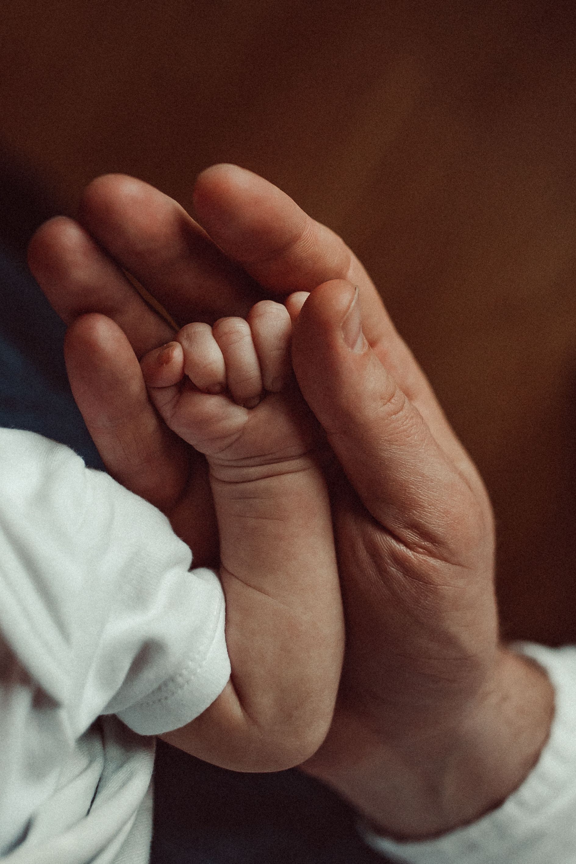 Tiny hand in dad's big hand