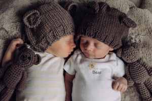 Newborn twins in matching hats