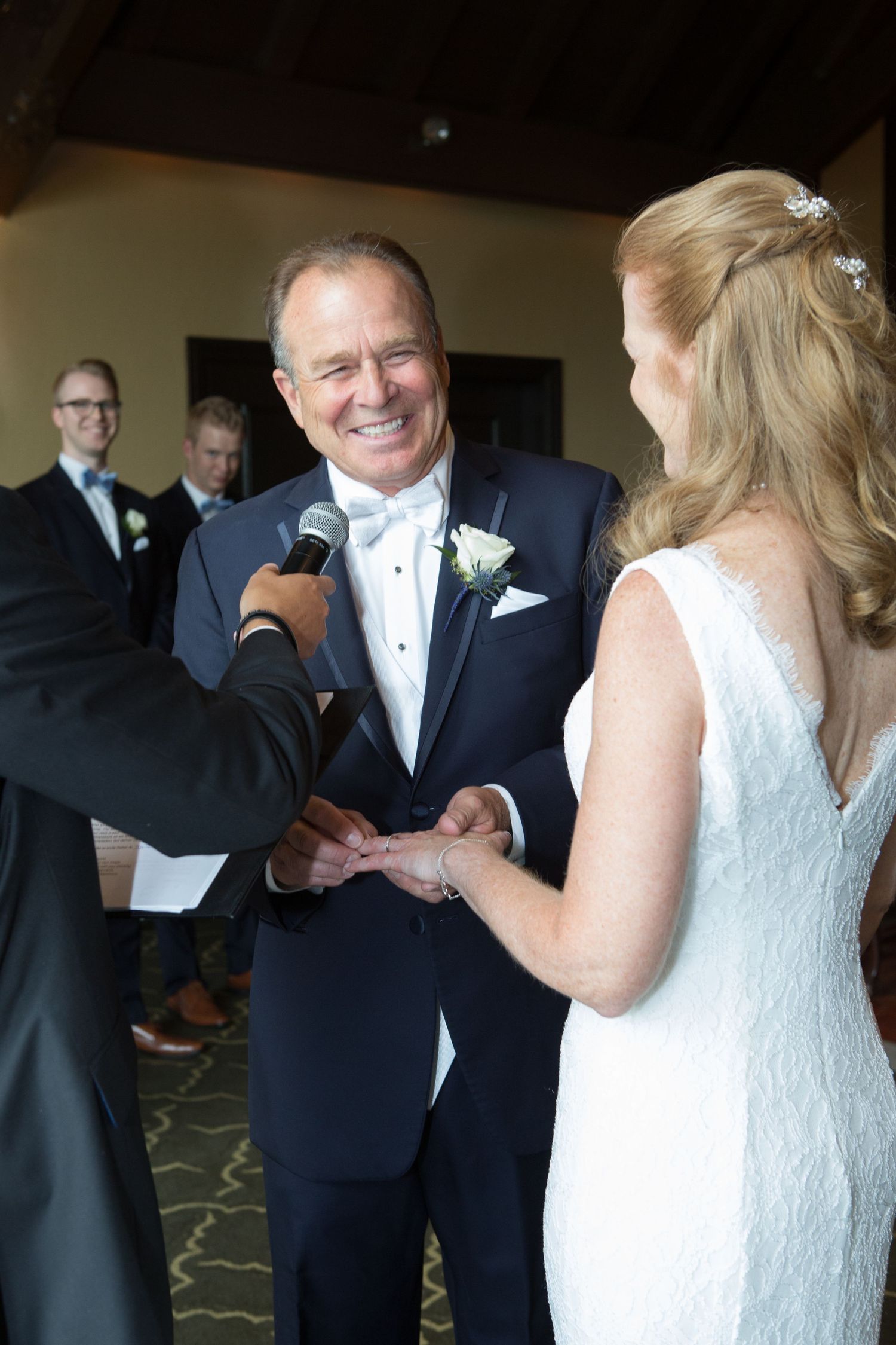 A wedding ceremony moment captured during the exchange of rings.