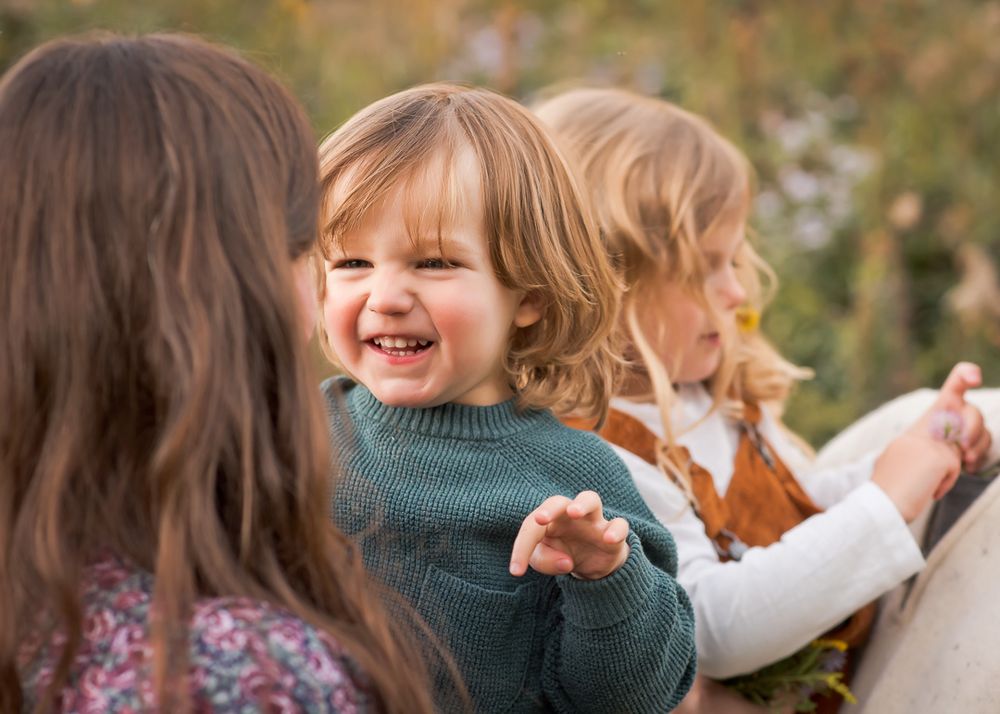 family photo with close up of happy toddler boy smiling at his mom