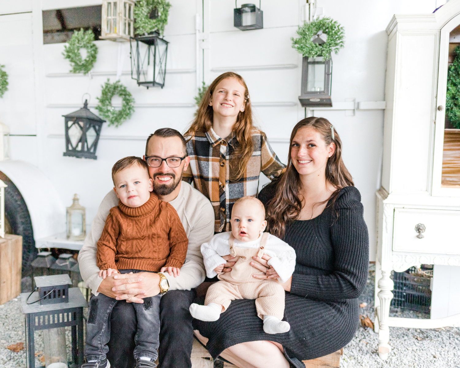 A stylish family posing together, showcasing coordinated holiday outfits during a photo session in the Hudson Valley.