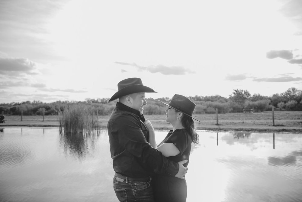 Beautiful couple posing in front of the lake. McAllen wedding photographer