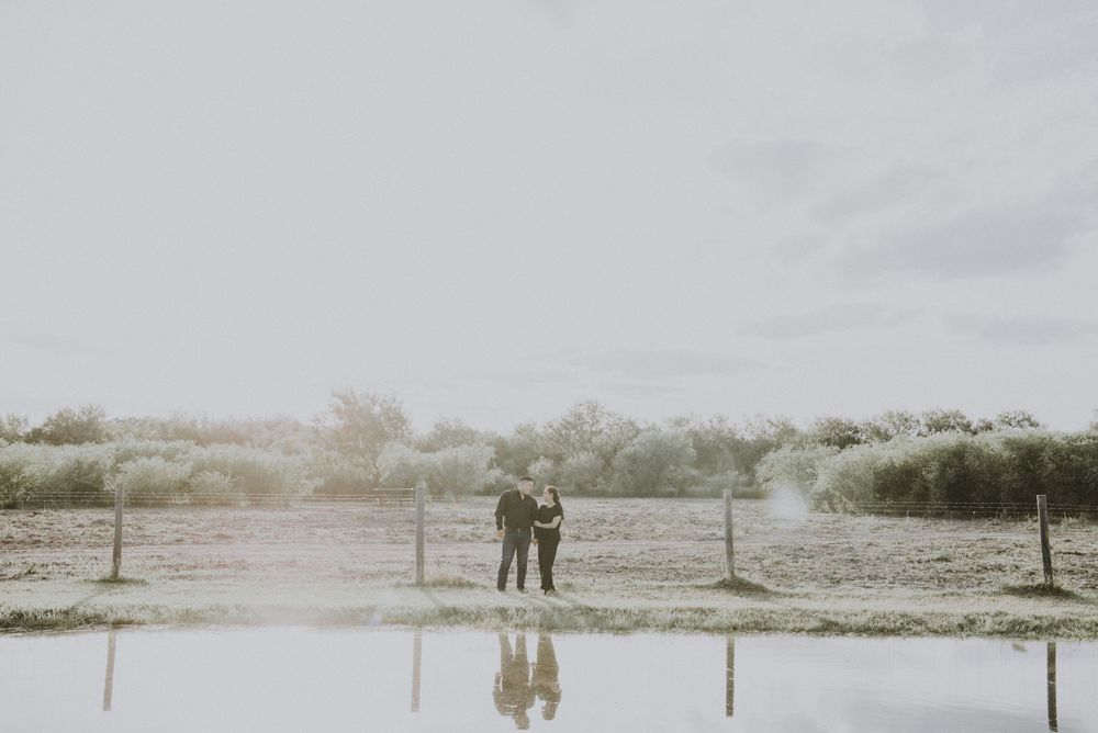 Couple standing next to a lake. Engagement session. McAllen photographer