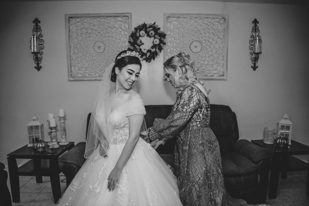 Mother helping bride fasten the dress. McAllen wedding photography
